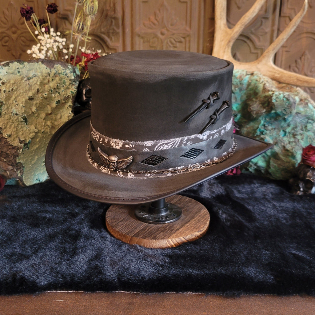 Black leather top hat featuring the leather inlays and nails on the hat.