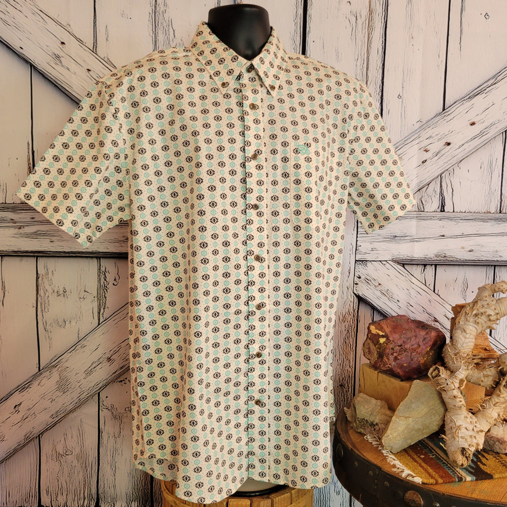 Cream shirt with Aztec patterns and a button front closure.