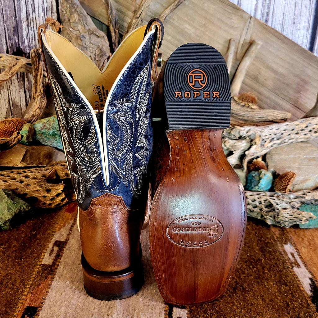 Pair of leather boots with conceal carry capability, blue shaft with detailed stitching, and weathered brown toe.
