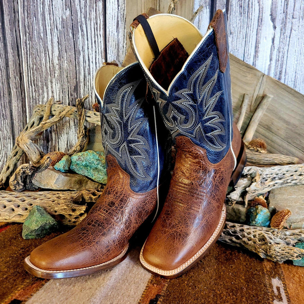 Pair of leather boots with conceal carry capability, blue shaft with detailed stitching, and weathered brown toe.