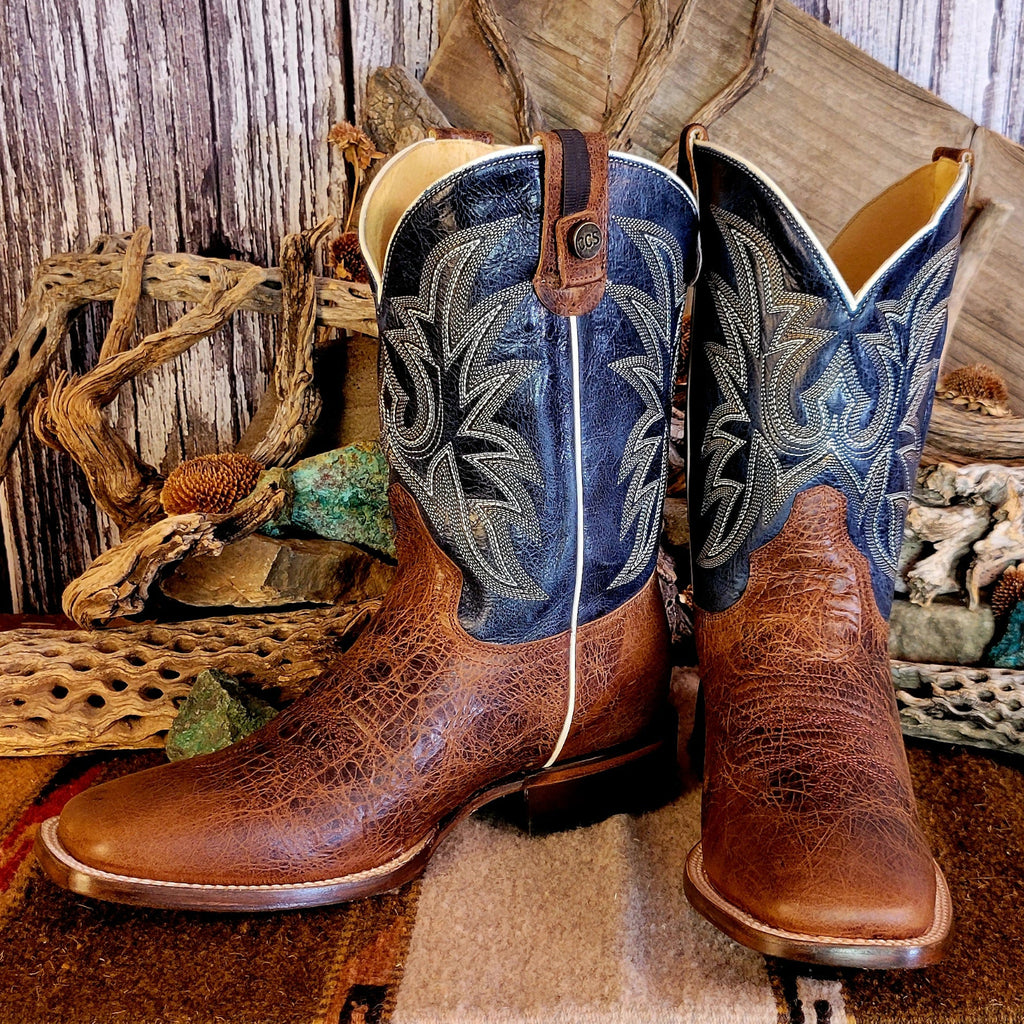 Pair of leather boots with conceal carry capability, blue shaft with detailed stitching, and weathered brown toe.