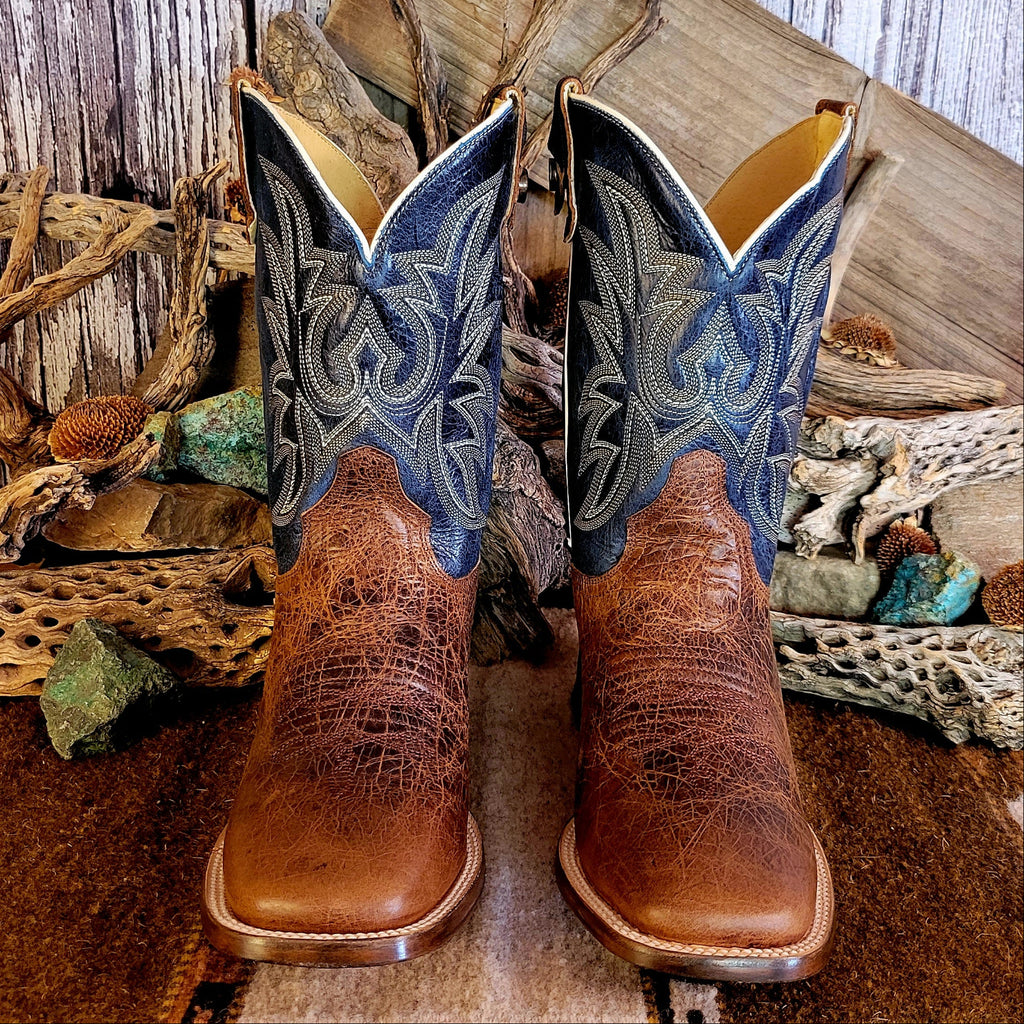 Pair of leather boots with conceal carry capability, blue shaft with detailed stitching, and weathered brown toe.
