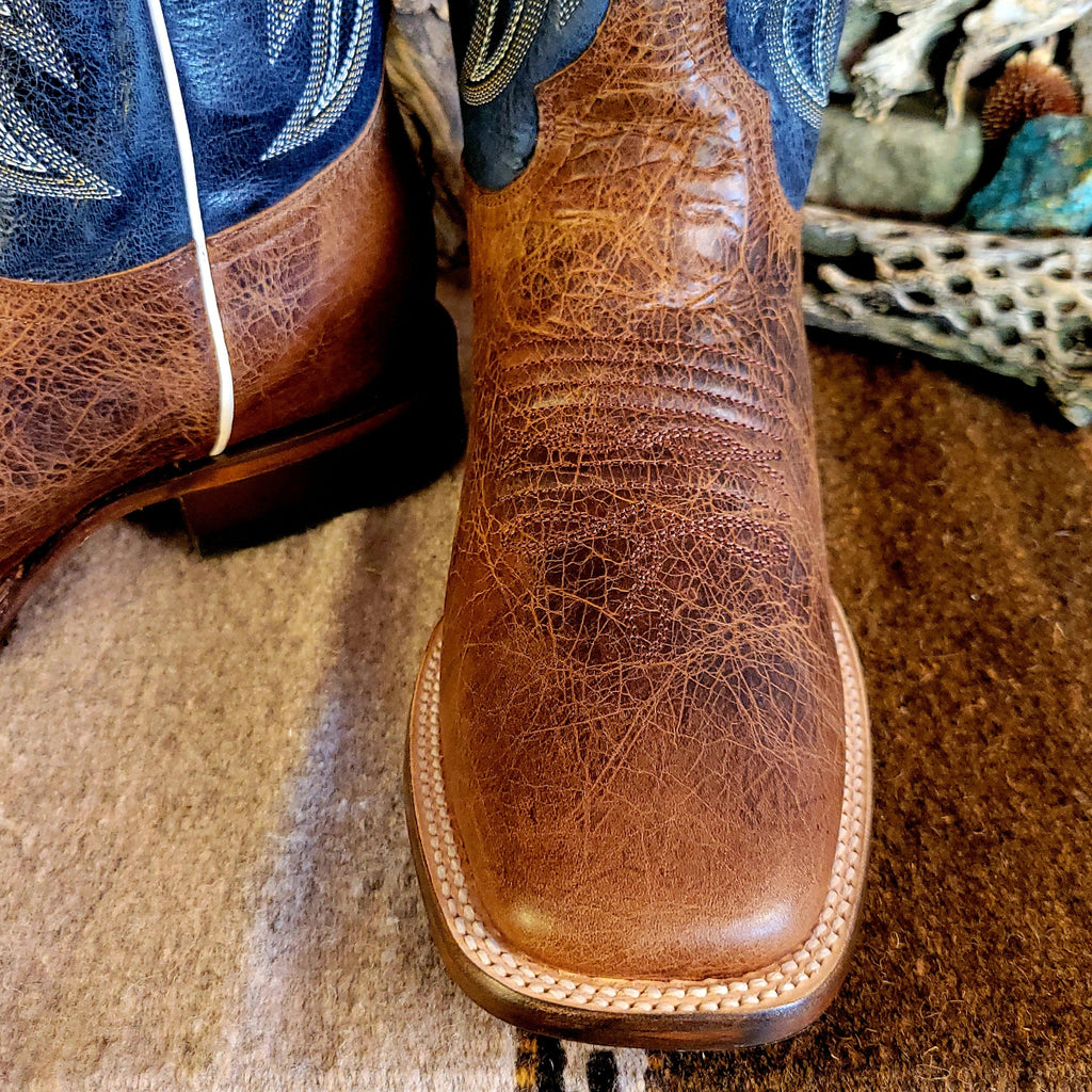 A close-up of the weathered brown leather toe on the boot.