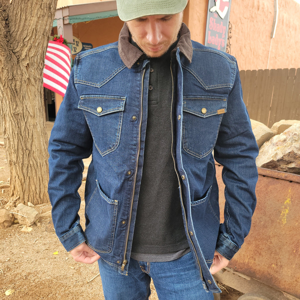 Denim jacket with multiple pockets, zipper and button design, and brown collar.