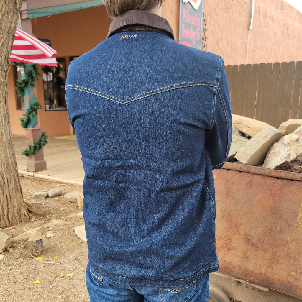 Denim jacket with multiple pockets, zipper and button design, and brown collar.