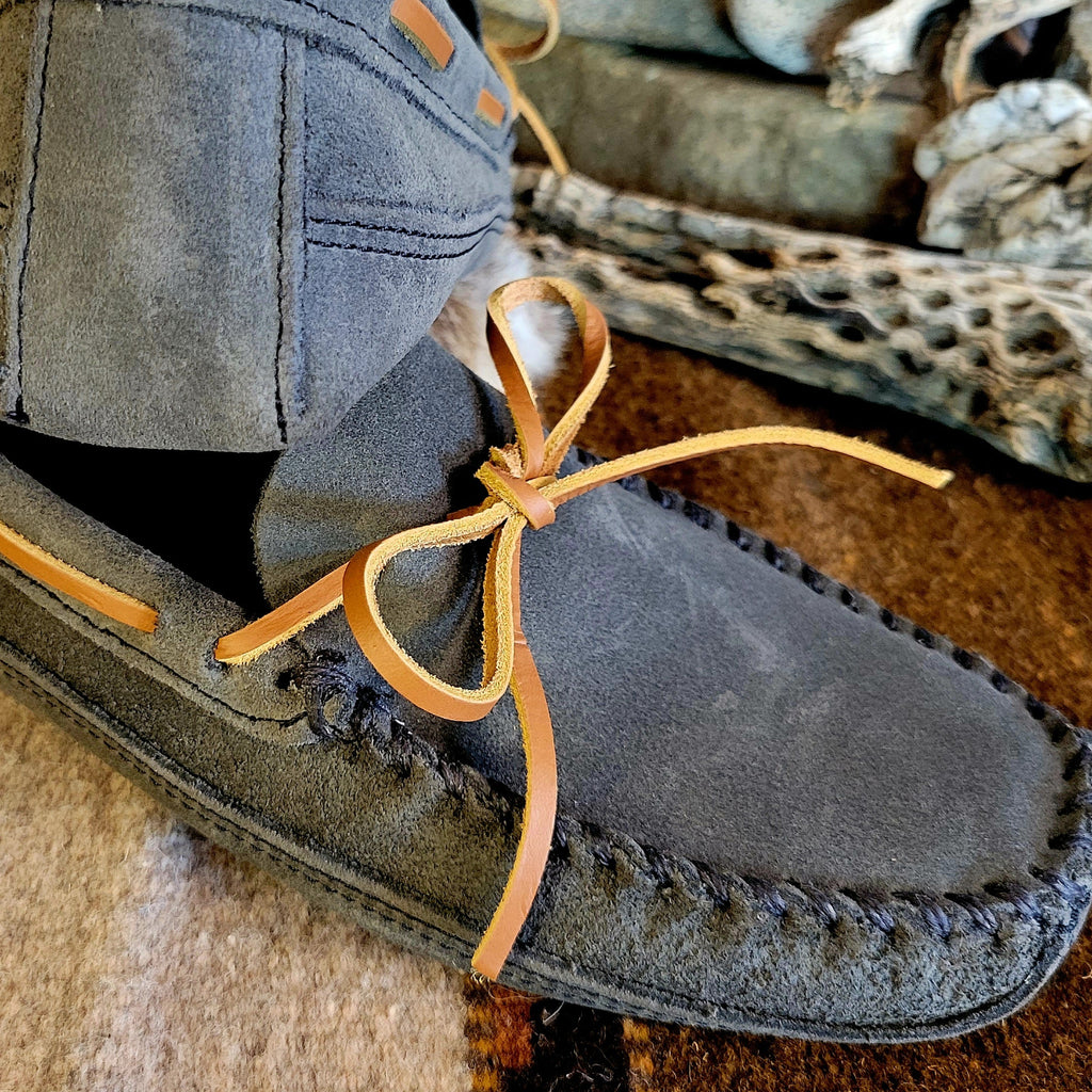 Close-up of the stitching and rawhide laces.