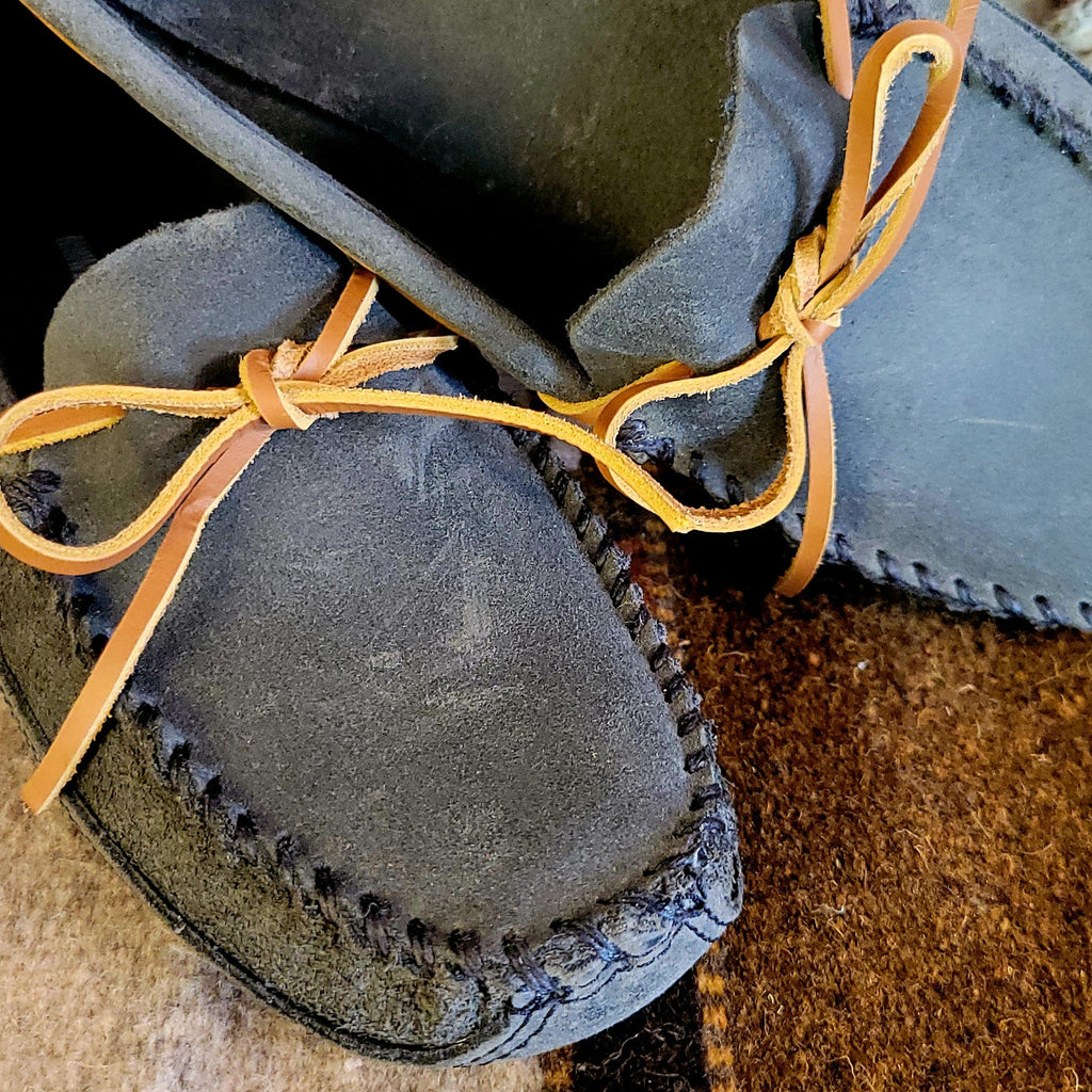 Close-up of the stitching and rawhide laces.