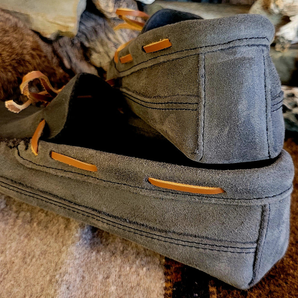 Close-up of the stitching and rawhide laces.