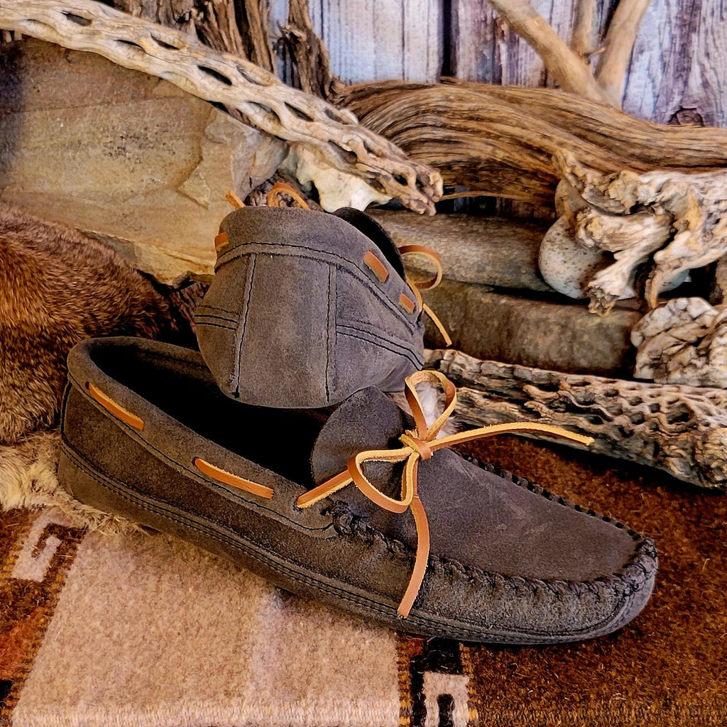 Pair of gray moccasins with rawhide laces.