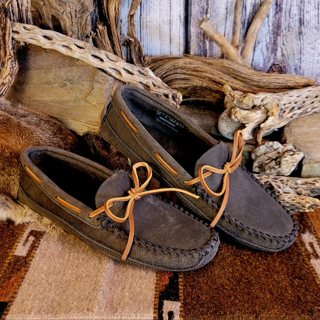 Pair of gray moccasins with rawhide laces.