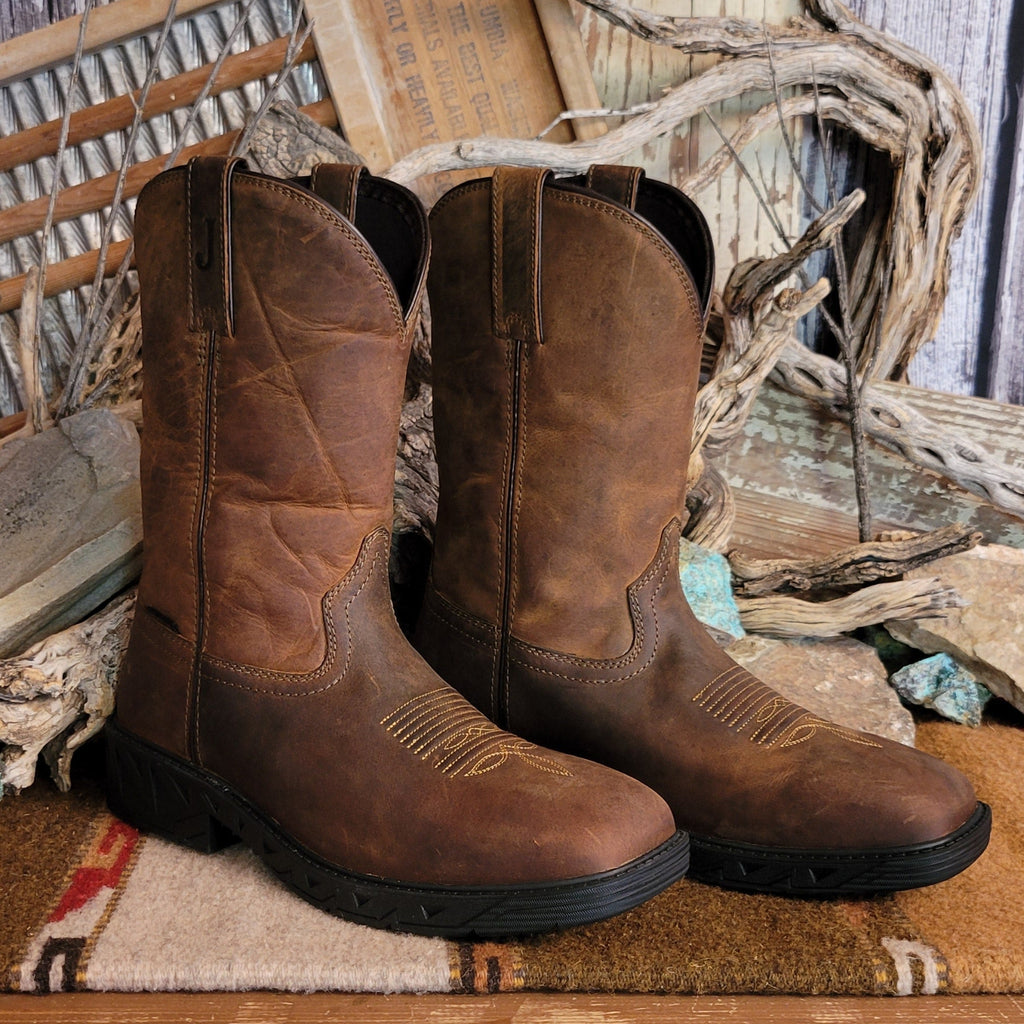 Brown leather boot with weathered appearance and cowboy stitching on the toe.