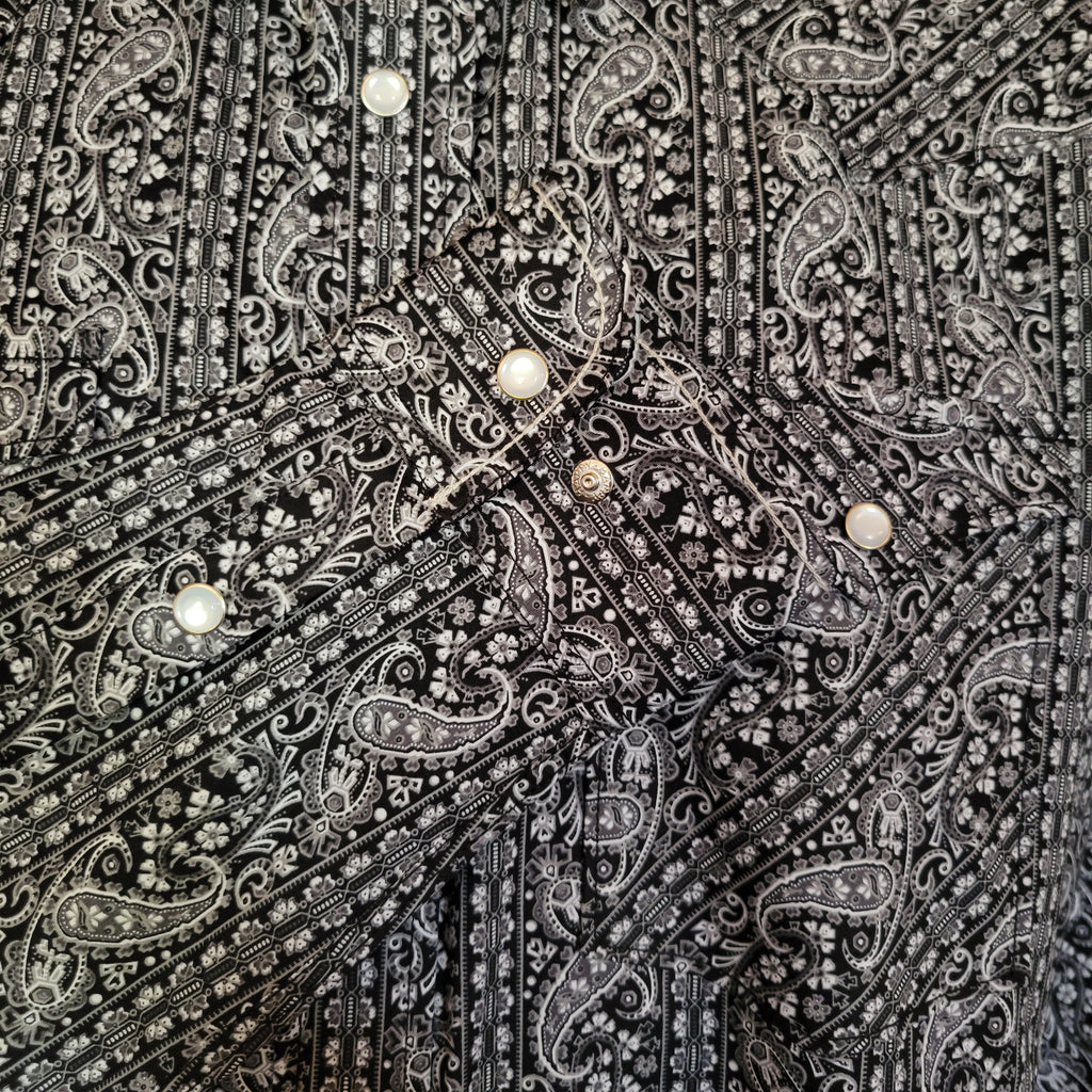 Close up of the black and white paisley pattern on the sleeve.