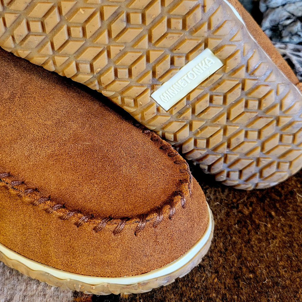 Close-up of the stitching on the moccasin slippers and rubber tread.