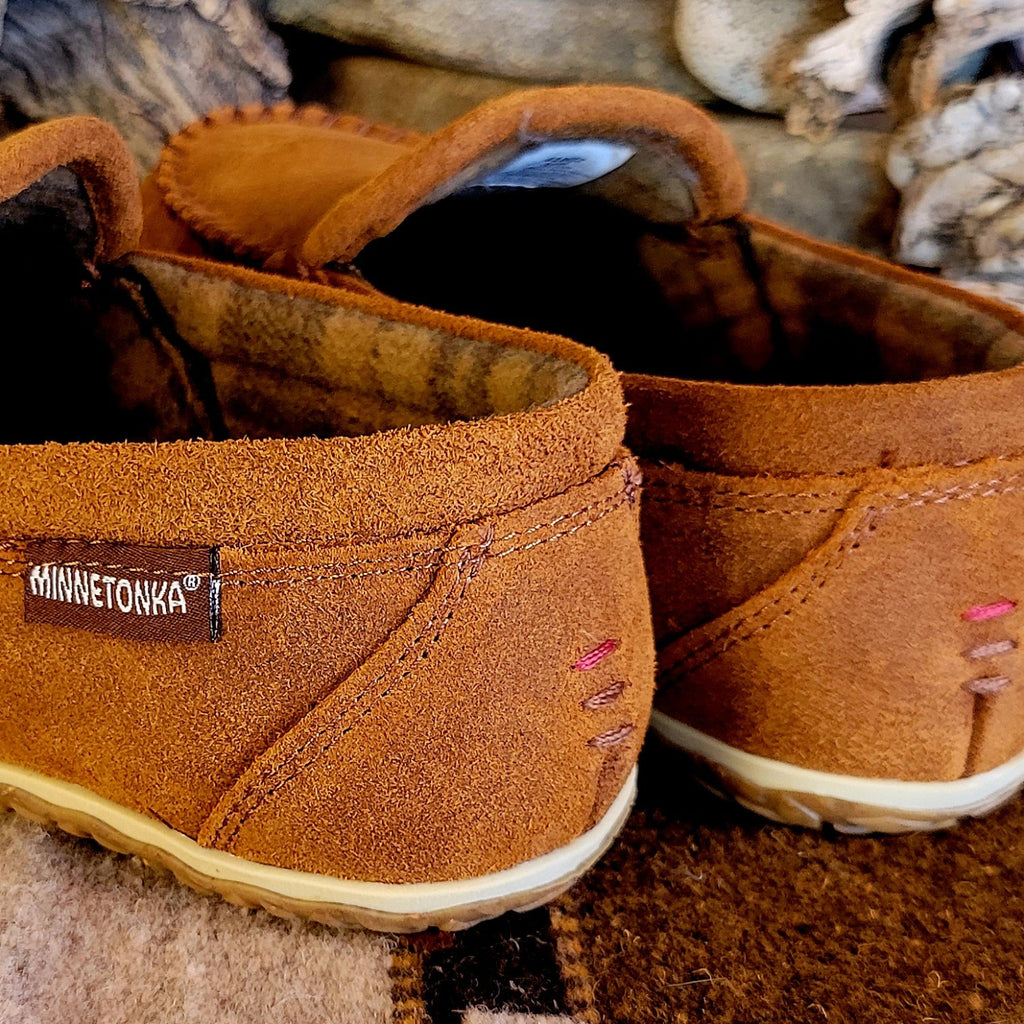 Close-up of the thread details on the back of the moccasin slippers.