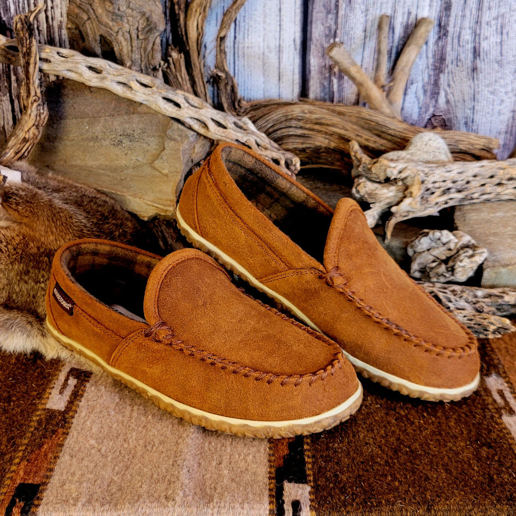 Pair of tan moccasin slippers with plaid, lined interior.