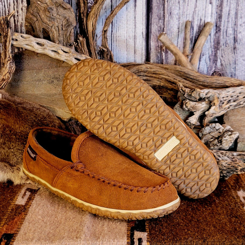 Pair of tan moccasin slippers with plaid, lined interior and rubber outsole.