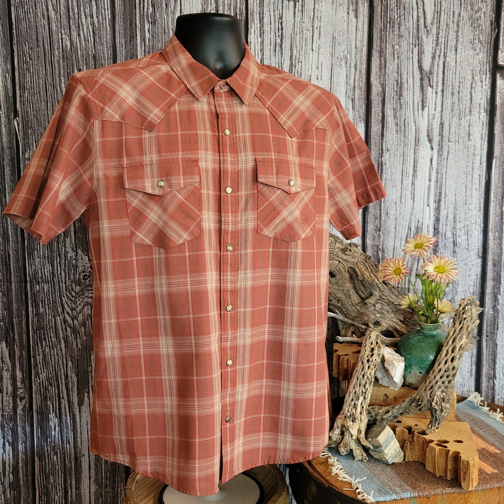 Rust-colored plaid shirt with short sleeves, featuring snap buttons and two chest pockets.
