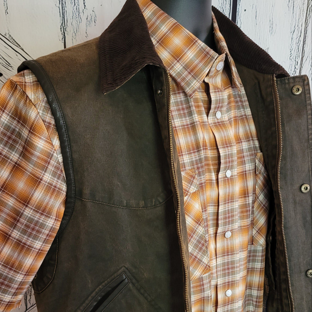Close-up of the vest’s corduroy collar and snap front with zipper.