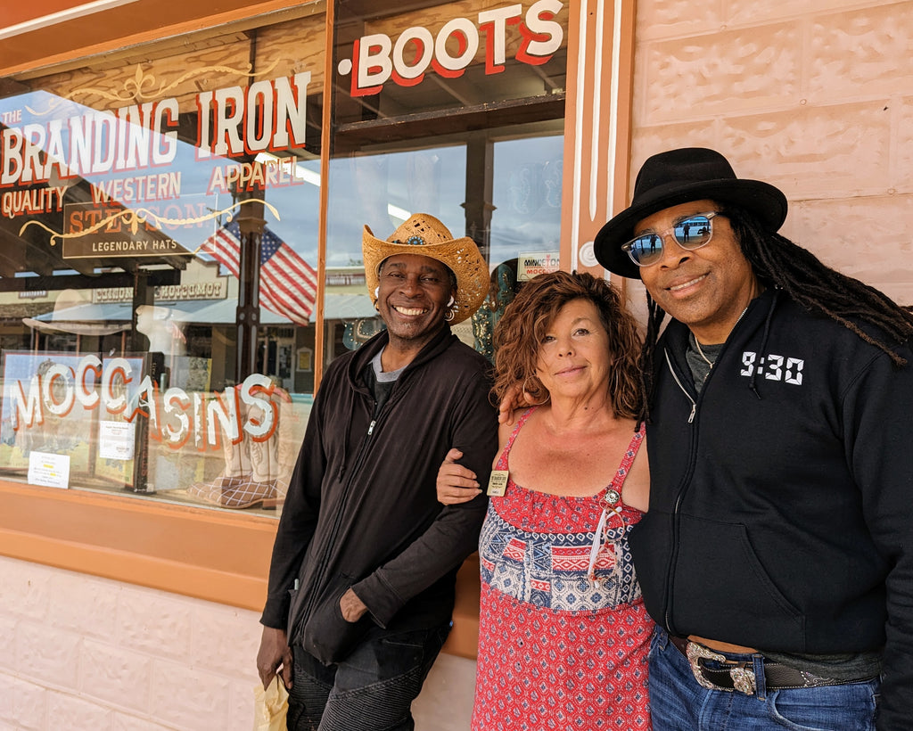 members of the band Living Colour pose with Branding Iron store manager