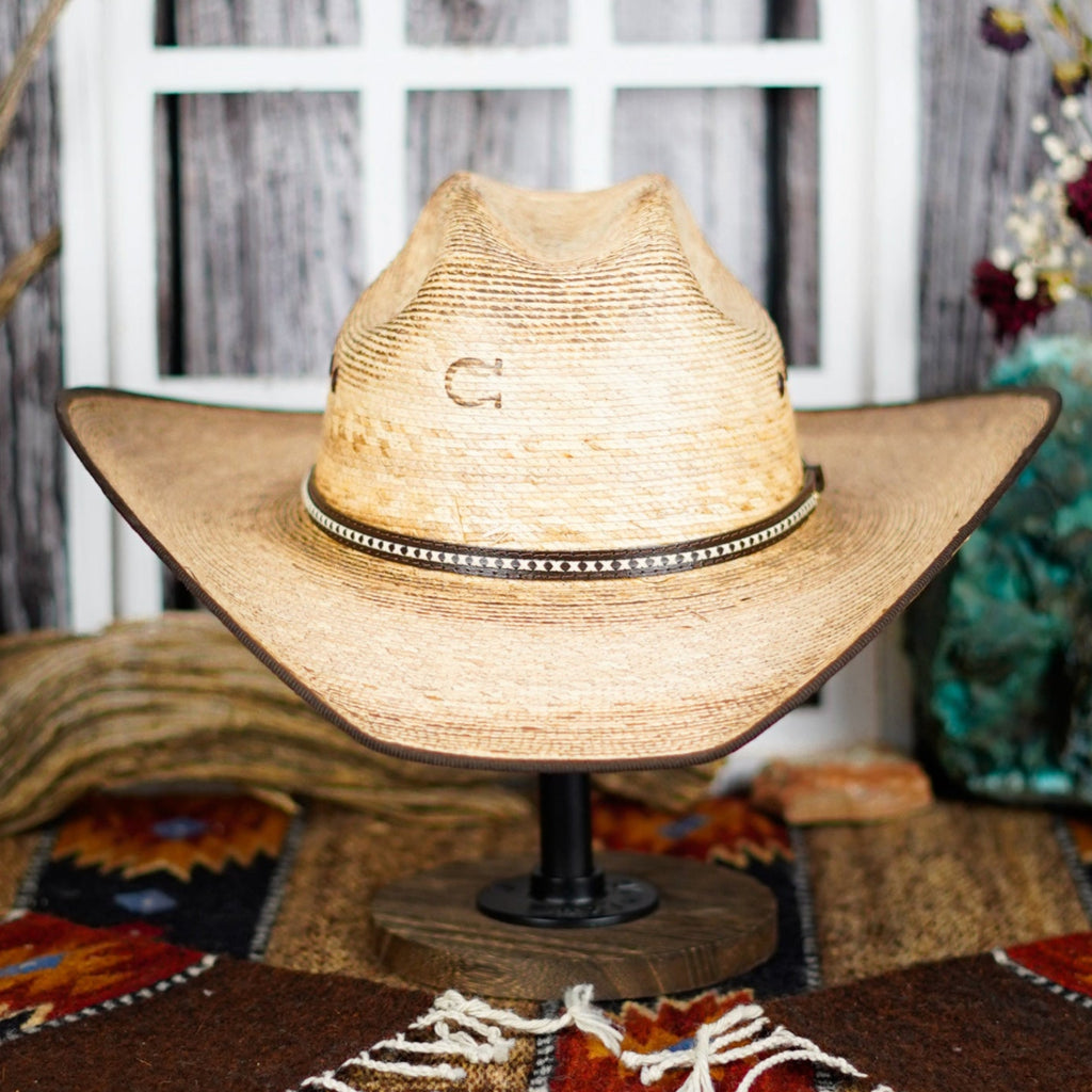 The front of the hat showcases its horseshoe brand and belt band.