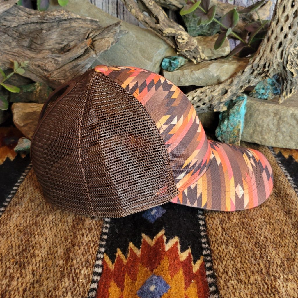 A southwestern trucker cap with a vibrant Aztec pattern and mesh panel.