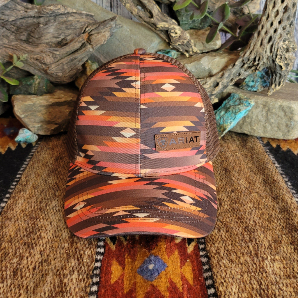 A southwestern trucker cap with a vibrant Aztec pattern and Ariat patch on the front.