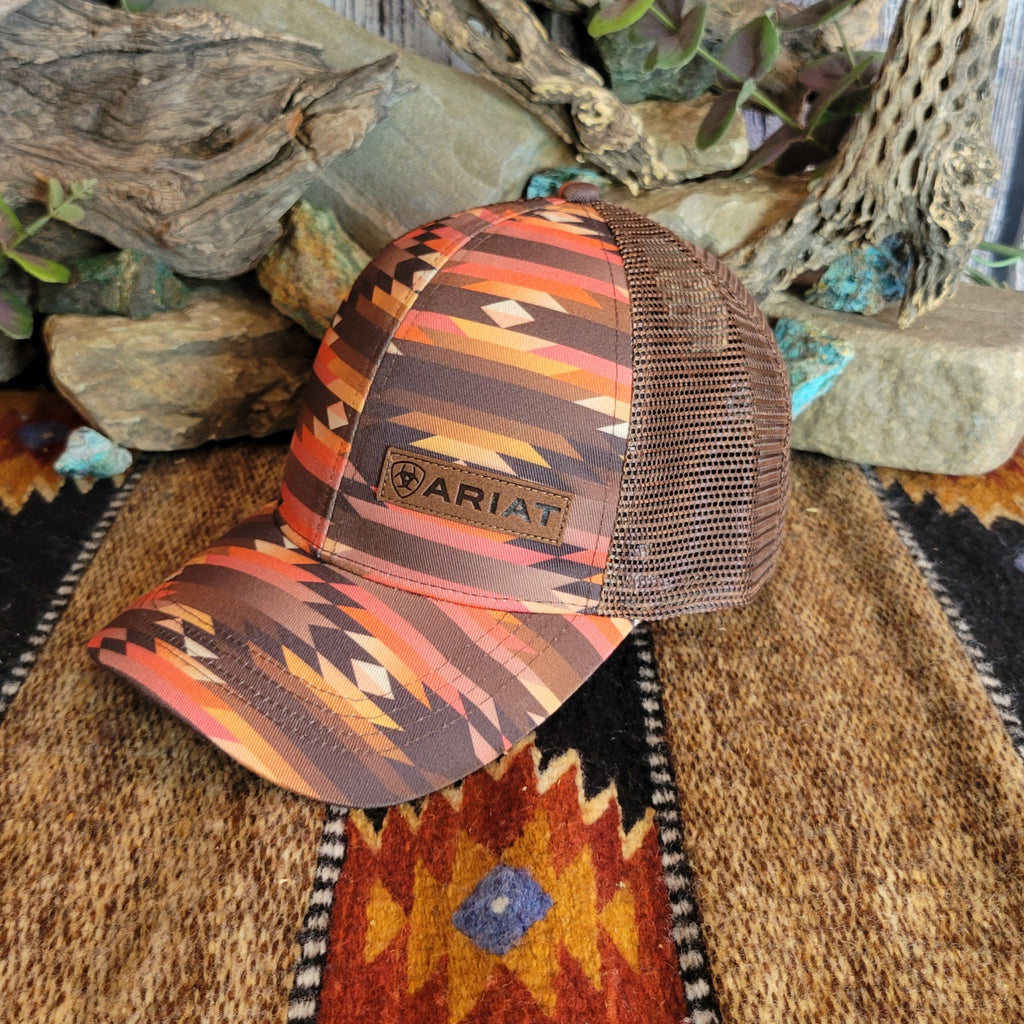 A southwestern trucker cap with a vibrant Aztec pattern and Ariat patch on the front.