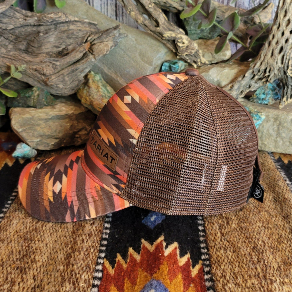 A southwestern trucker cap with a vibrant Aztec pattern and mesh panel.