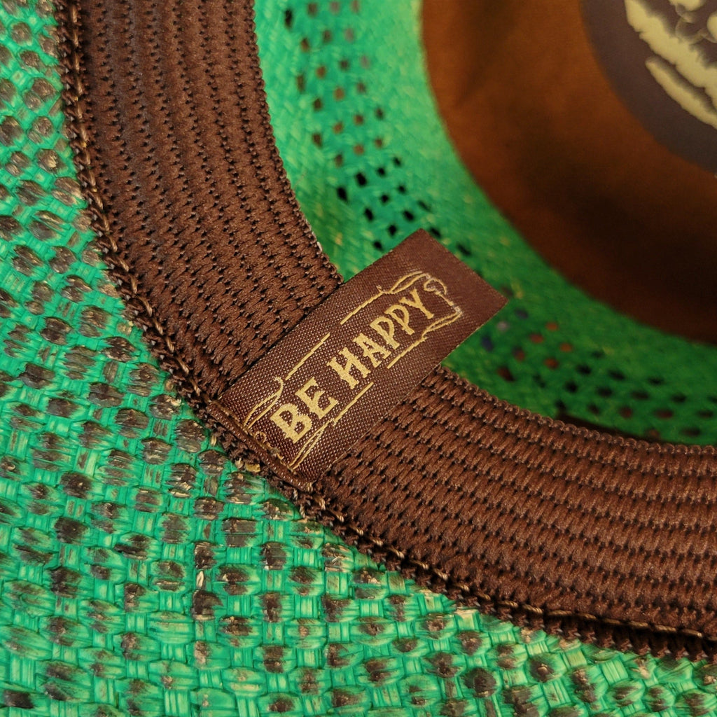 The brand's slogan is featured inside the cap saying "Be happy".