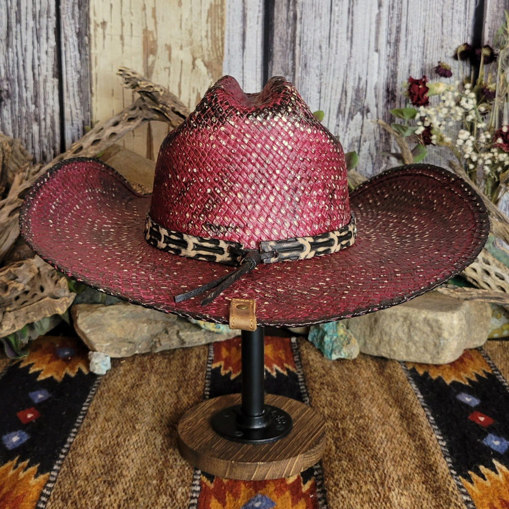 The back of the hat showcases the hat band with leather cords and a tan leather button-tag.