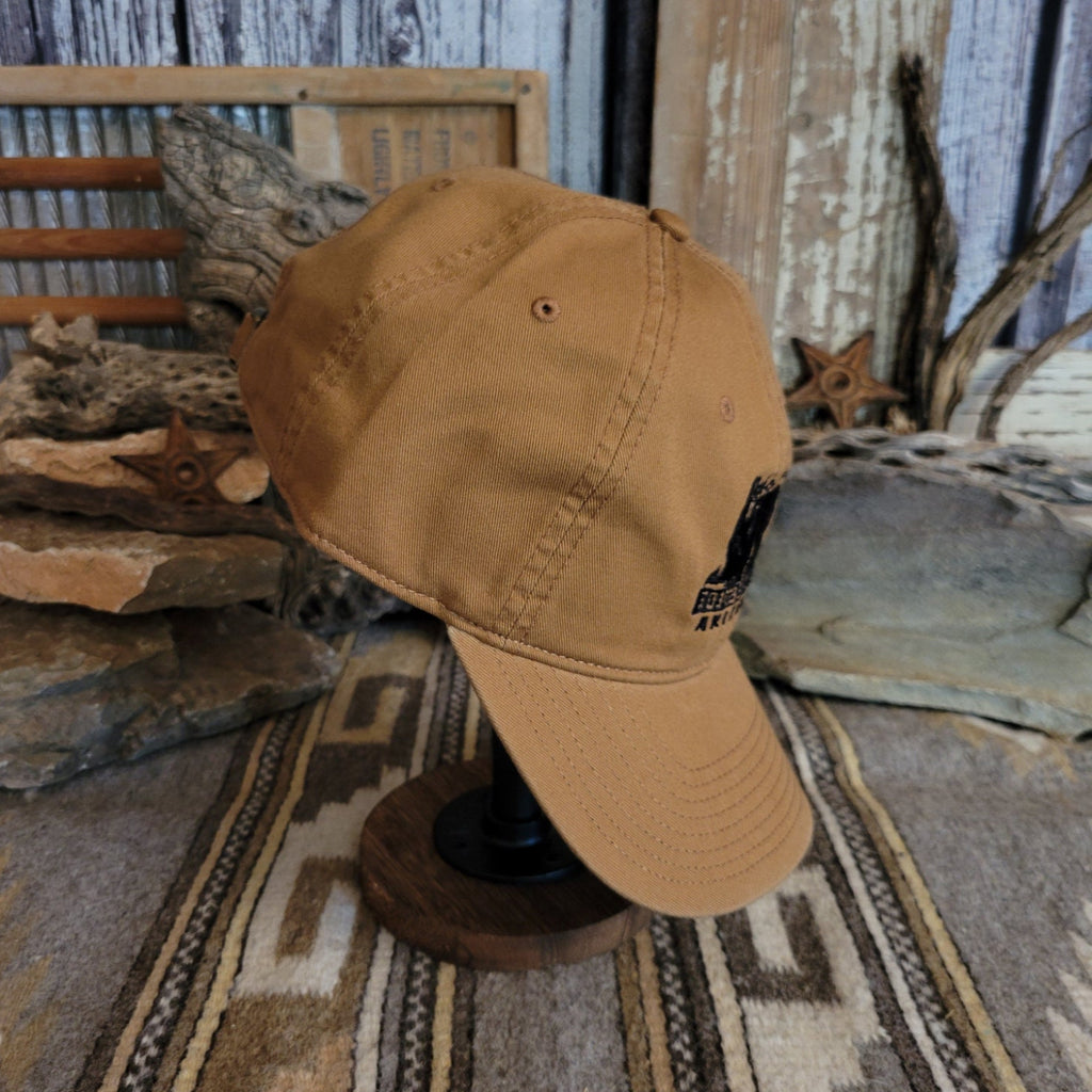 Tan cap with a curved bill, showcasing clean stitching.