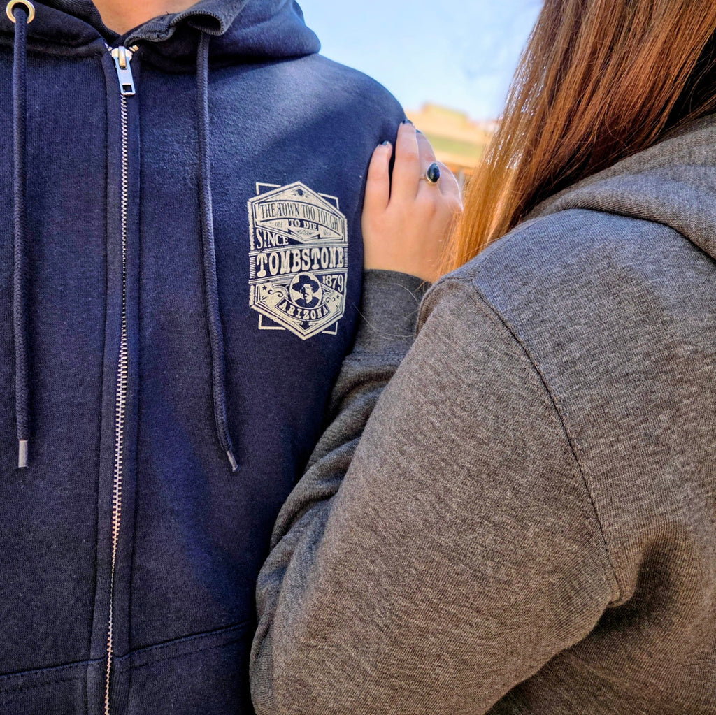 A couple of outlaws rockin' the Tombstone Zip Up Hoodie by Black Anchor (LS14003) in the dusty streets of Tombstone, AZ