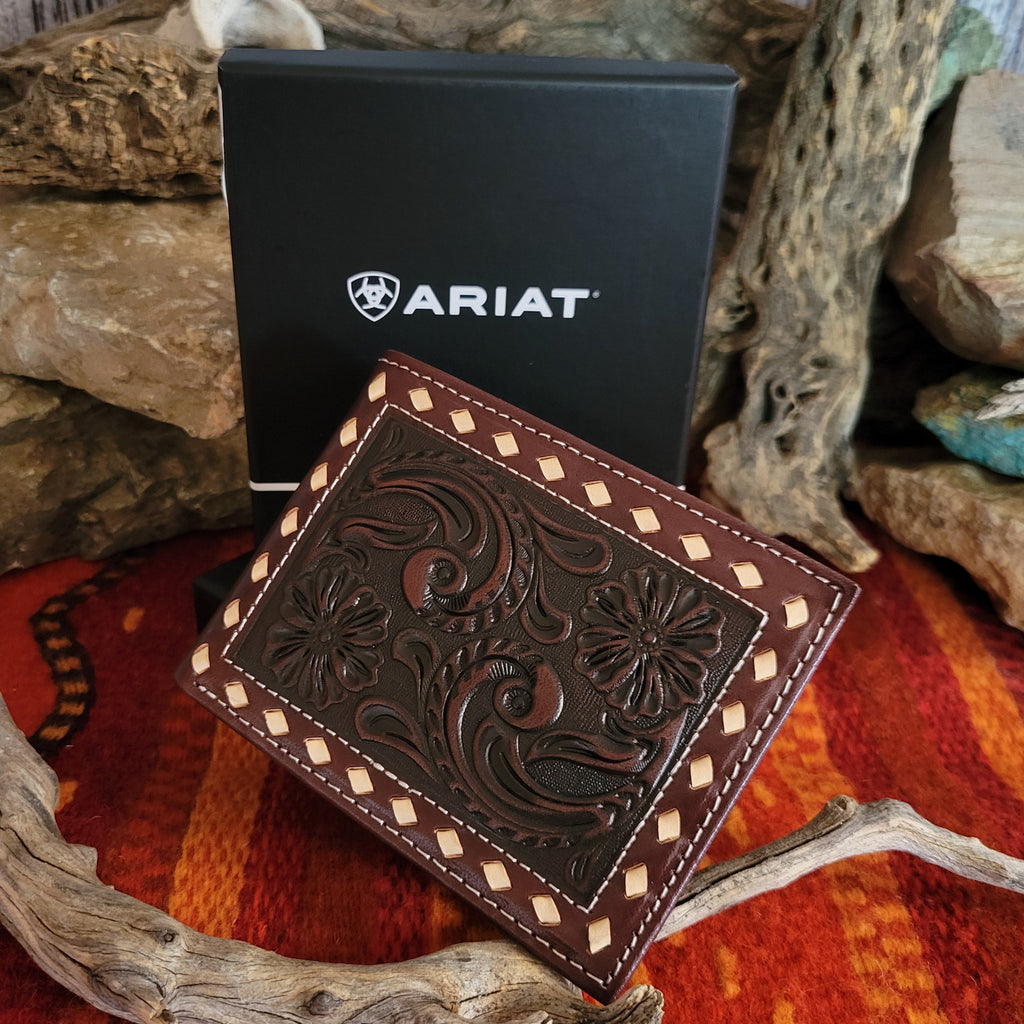 Dark brown leather wallet with tooled vine patterns.