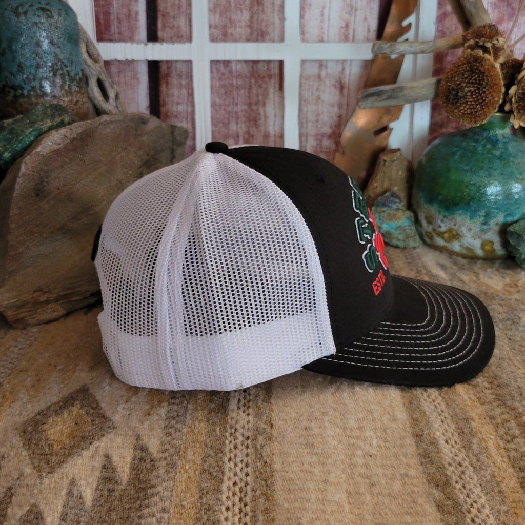 Side view of the hat showing the black fabric with white mesh panel.