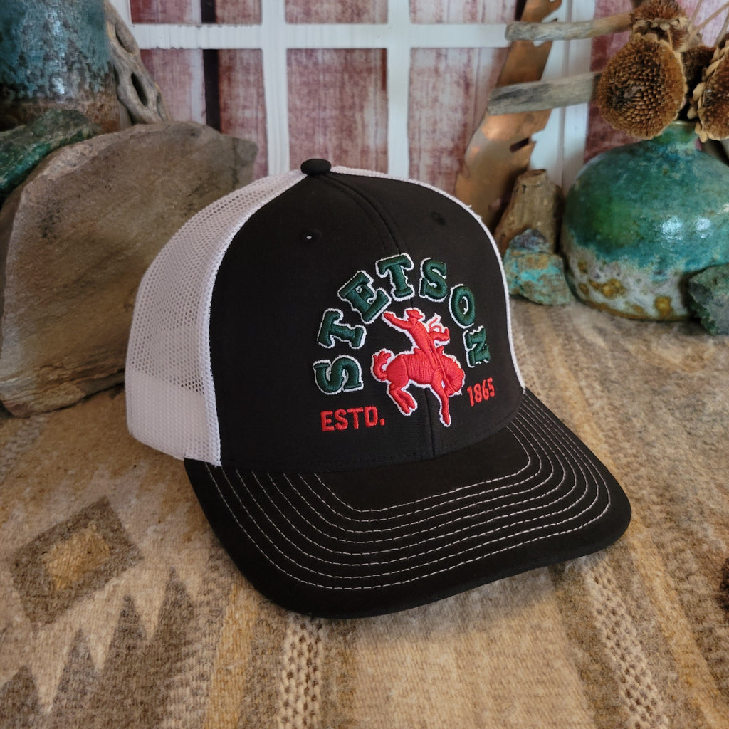 A black and white mesh cap features a bold embroidered bronco rider logo.