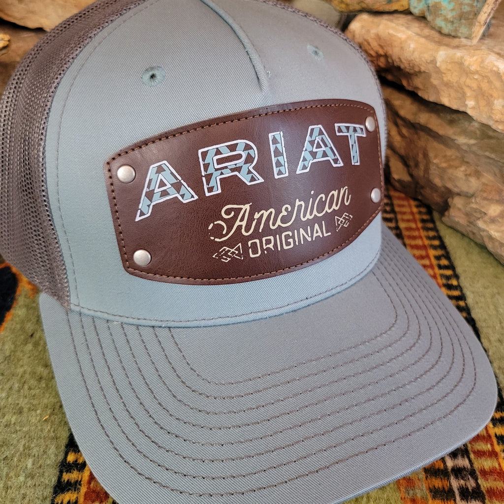 Close up view of the brown leather patch reading "Ariat, American Original."