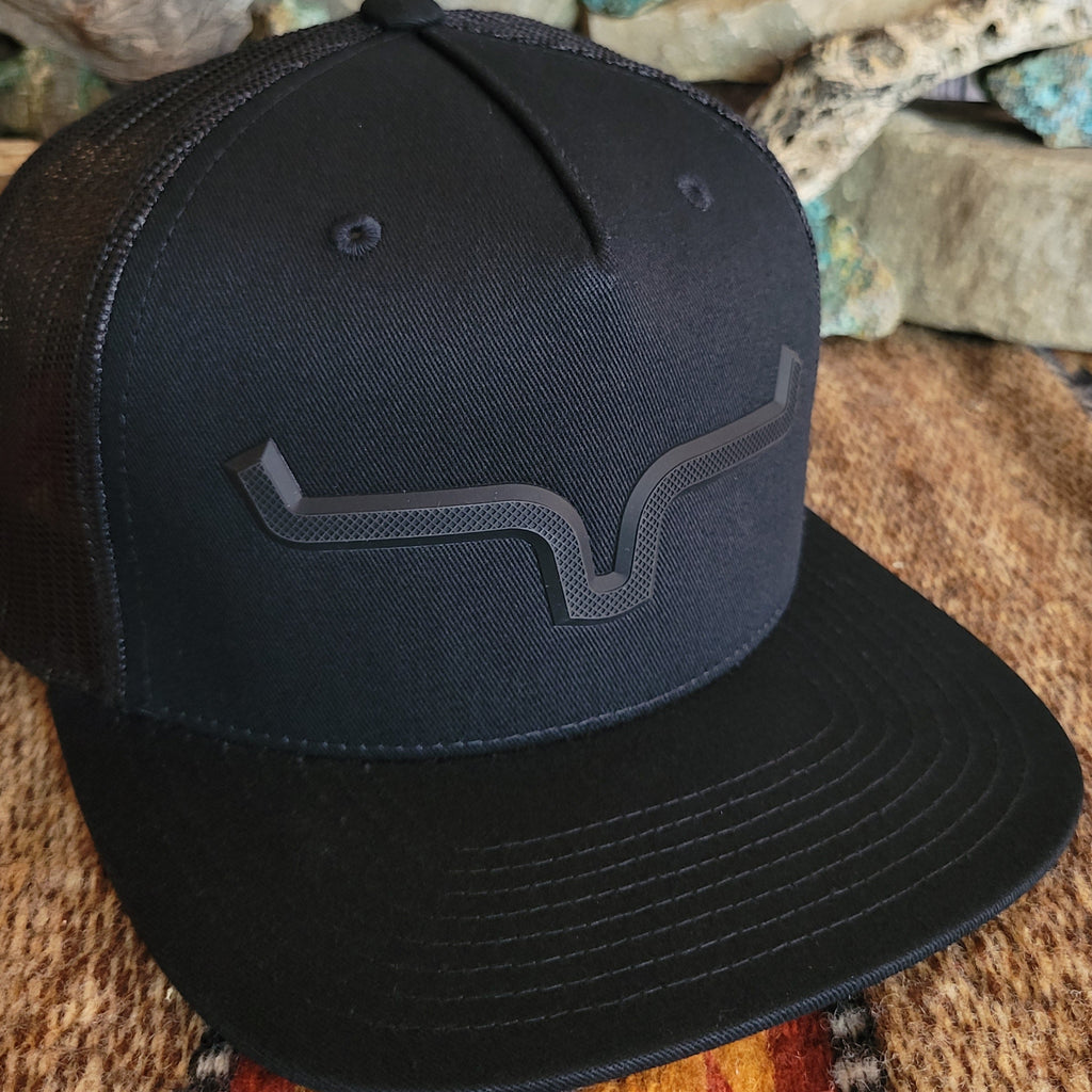 A close-up view of the blacked-out Kimes Ranch logo on the front of the cap.
