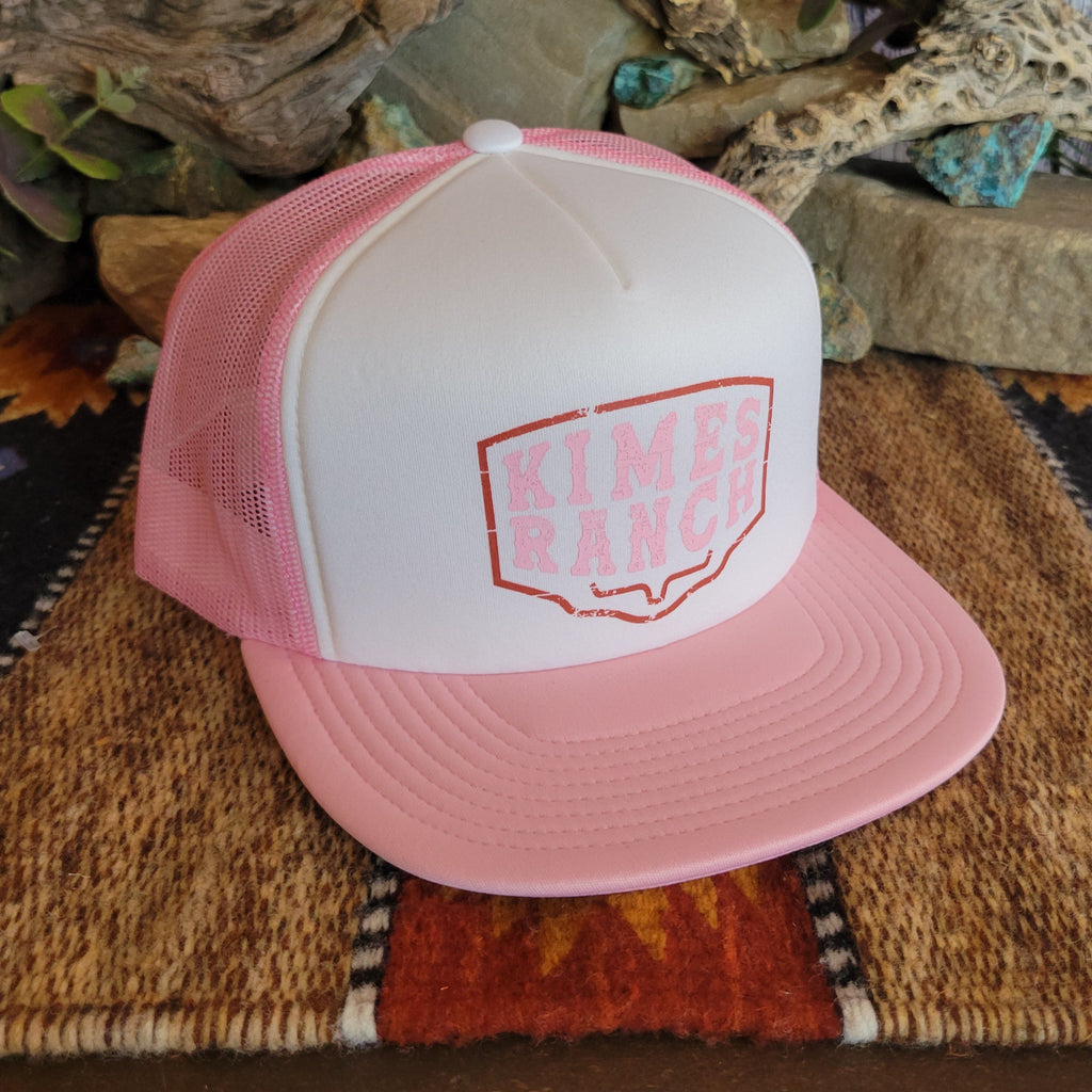 A pink trucker cap with pink mesh paneling, featuring the "Kimes Ranch" logo.
