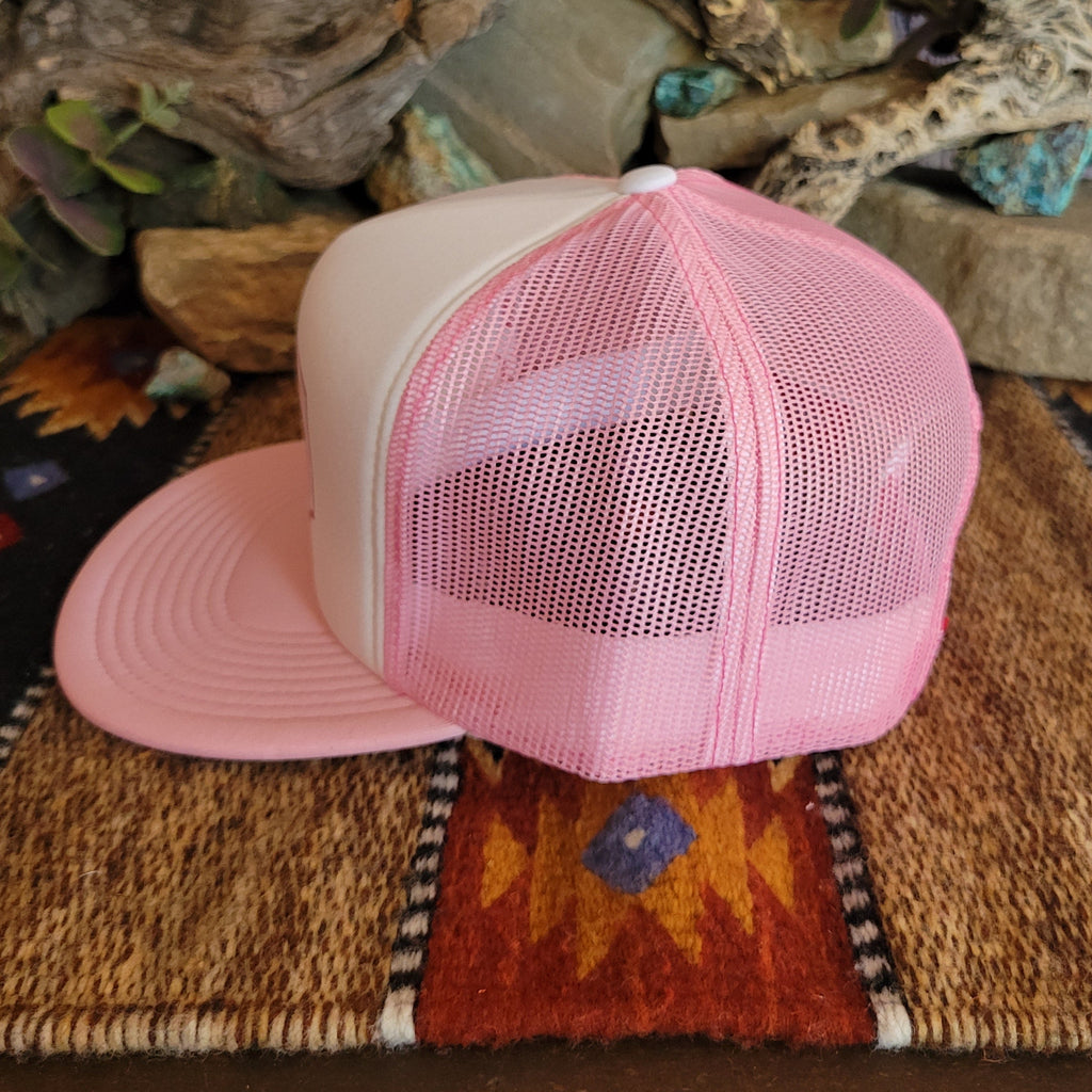 A pink trucker cap with pink mesh paneling.