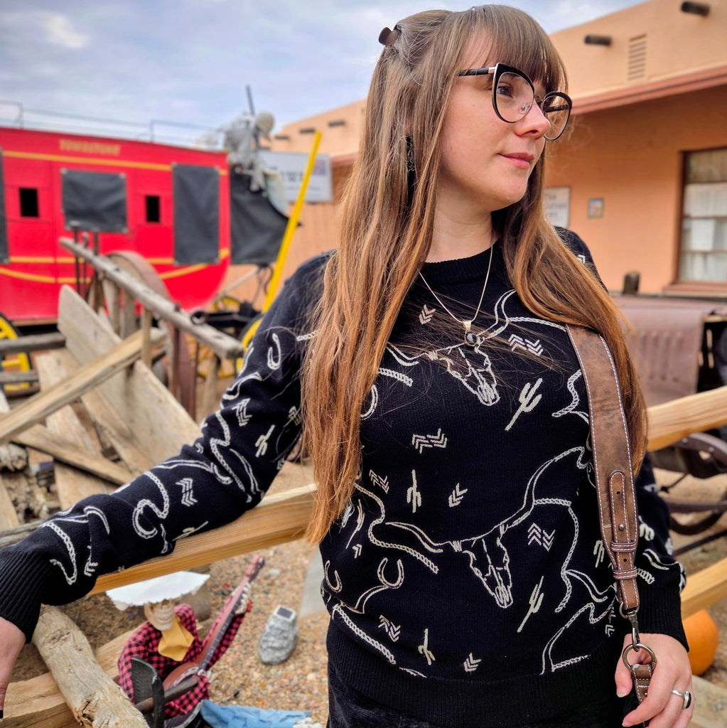 Women's Ainsley Black Crewneck Sweater with white steer skulls and cactus print by Outback Trading close up