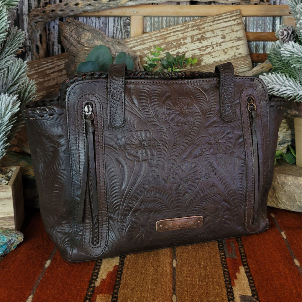 Hand-stained red and rich brown, tote has concealed carry pockets and hand-tooled floral designs.