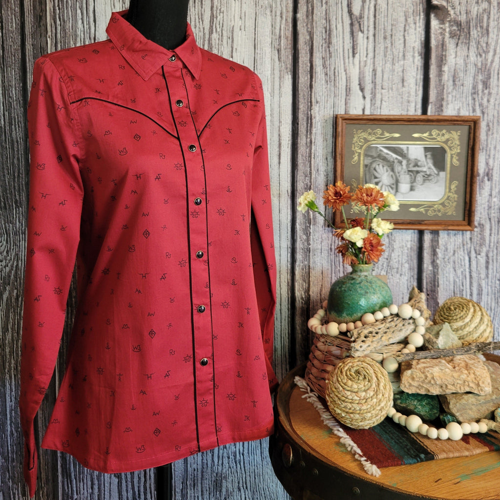 Red long sleeve shirt with snap on buttons and cattle brand print.