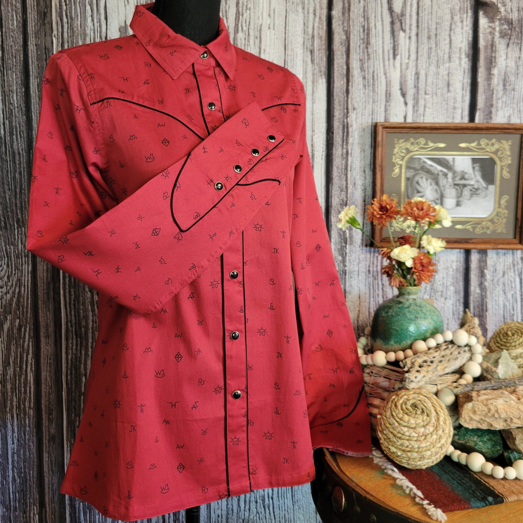 Red long sleeve shirt with snap on buttons and cattle brand print.
