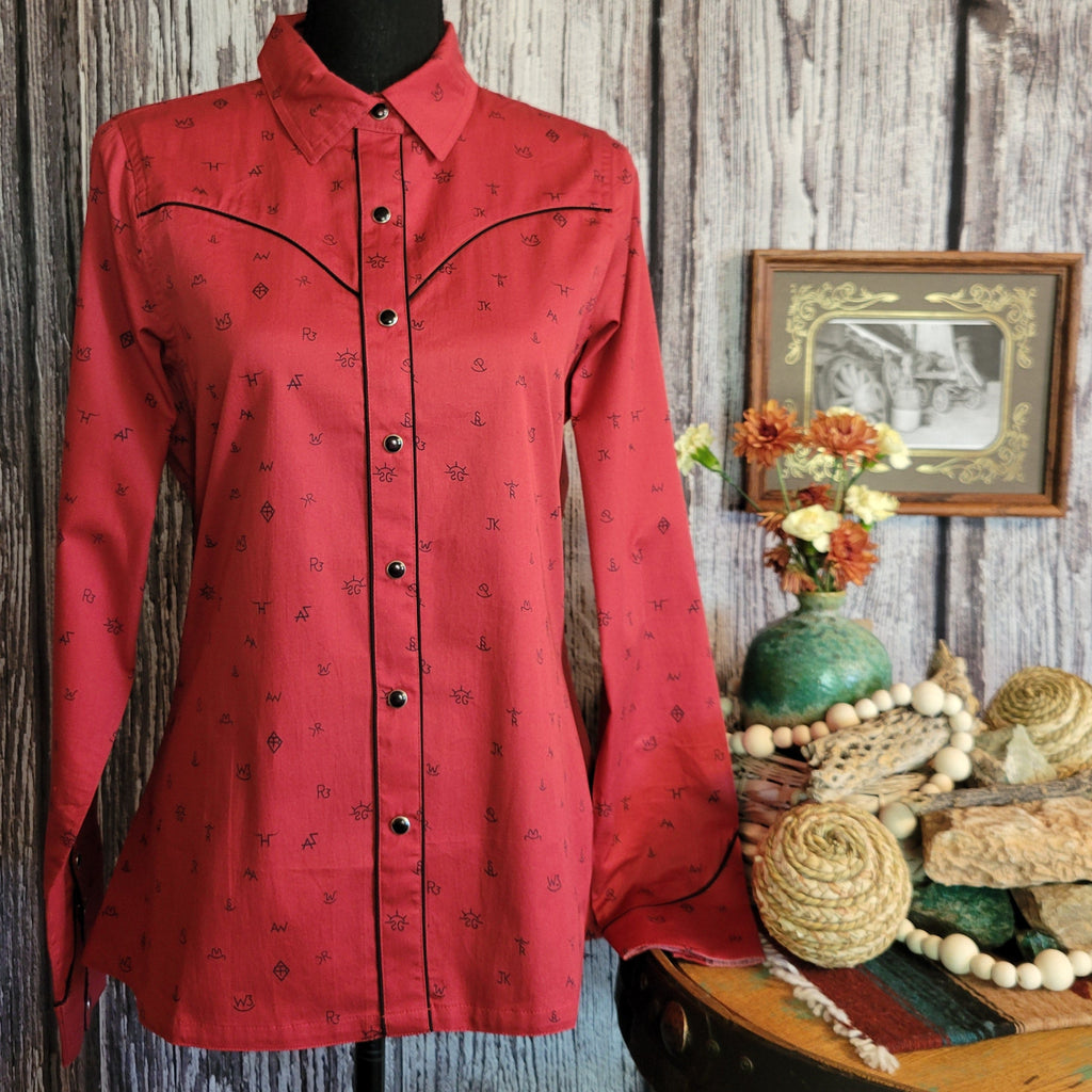 Red long sleeve shirt with snap on buttons and cattle brand print.