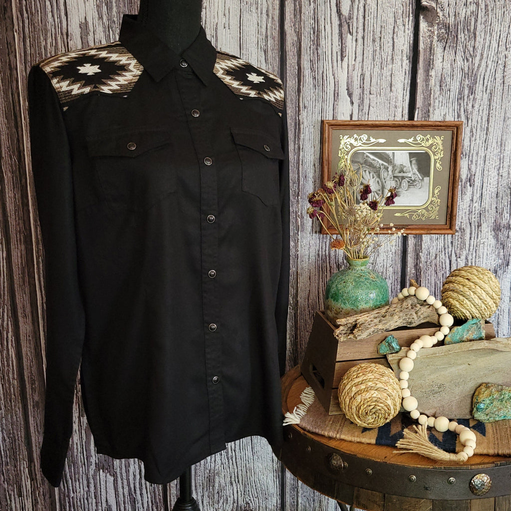 Black button down shirt with southwestern embroidery design on the shoulders and snap buttons.