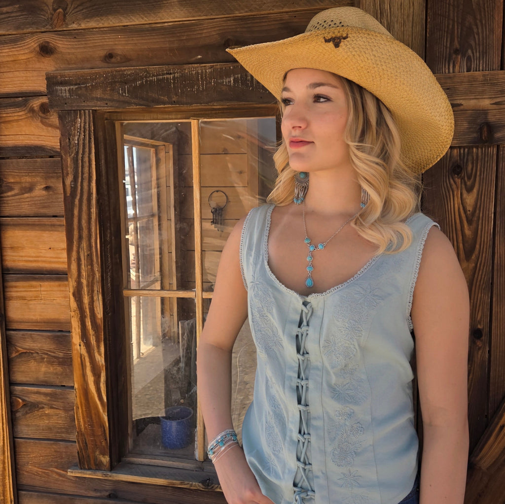 Light blue top with tie front and floral detailing.