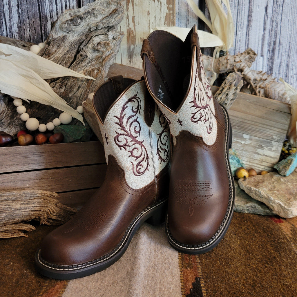 Brown cowgirl boot with dark brown toe and white shaft featuring intricate brown stitching.