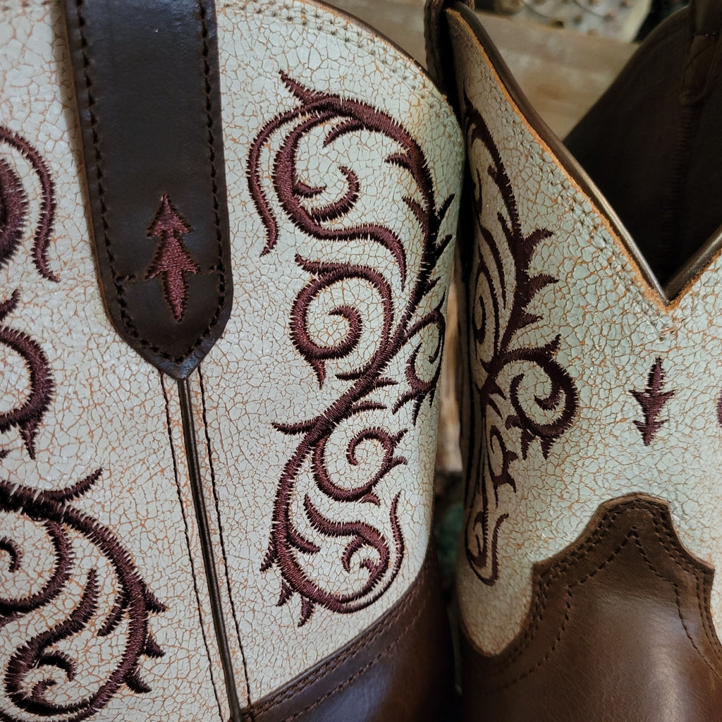 Close-up of the intricate brown stitching on the white shaft.
