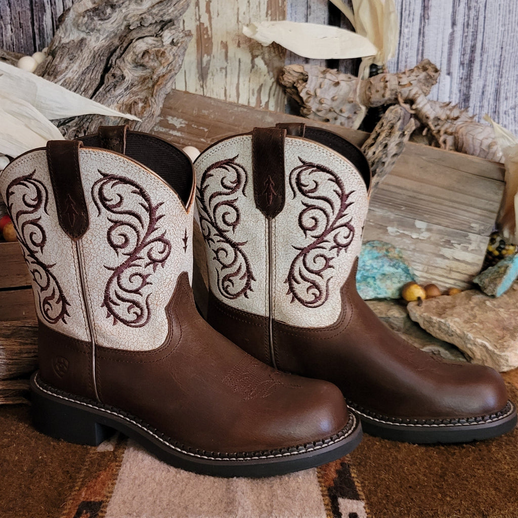 Brown cowgirl boot with dark brown toe and white shaft featuring intricate brown stitching.