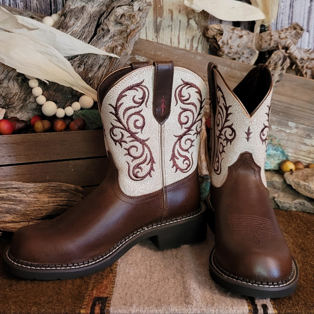 Brown cowgirl boot with dark brown toe and white shaft featuring intricate brown stitching.